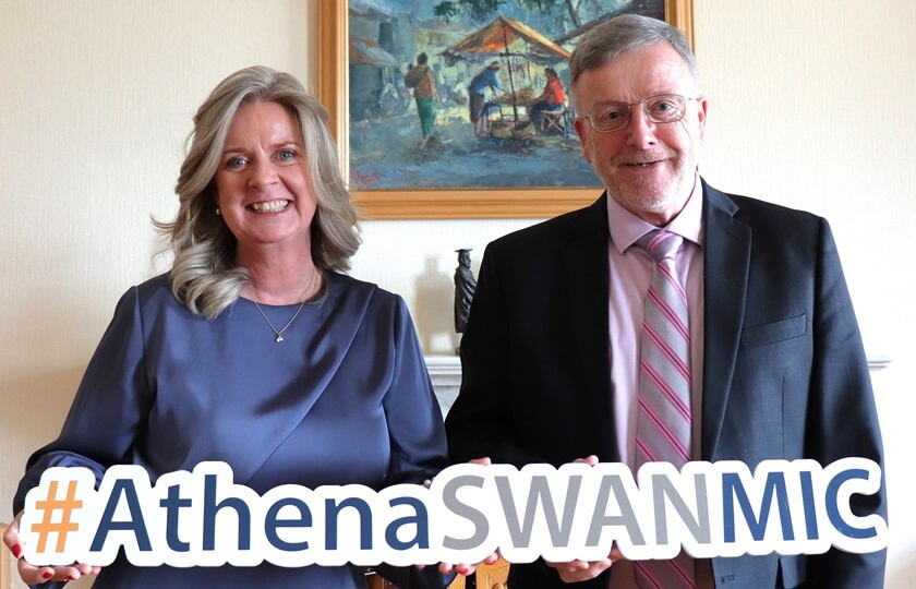 MIC President Eugene Eugene Wall and Professor Lorraine McIlrath, Director of EDII holding an Athena Swan sign. 
